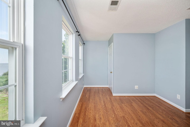 9129 Pebble Beach Ln, King George, VA 22485 - spare room featuring wood finished floors, a textured ceiling, and baseboards