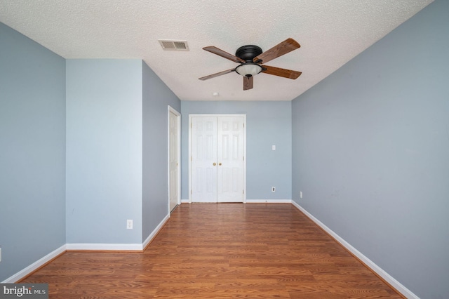 9129 Pebble Beach Ln, King George, VA 22485 - spare room with a ceiling fan, wood finished floors, baseboards, and a textured ceiling