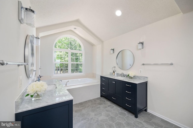 9129 Pebble Beach Ln, King George, VA 22485 - bathroom with vaulted ceiling, a textured ceiling, a garden tub, vanity, and tile patterned flooring
