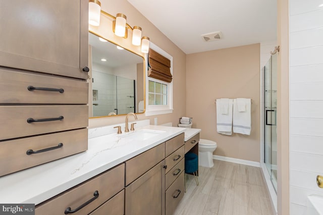 4401 Aragon Pl, Alexandria, VA 22309 - full bath with vanity, baseboards, toilet, a shower stall, and wood finished floors