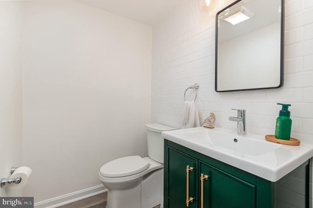 4401 Aragon Pl, Alexandria, VA 22309 - half bathroom with vanity, toilet, wood finished floors, tasteful backsplash, and baseboards