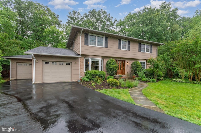 4401 Aragon Pl, Alexandria, VA 22309 - colonial house with a garage, driveway, a front lawn, and brick siding