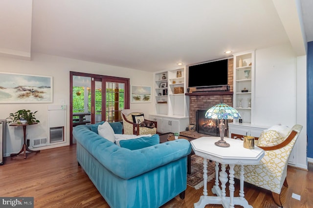4401 Aragon Pl, Alexandria, VA 22309 - living area with a brick fireplace, wood finished floors, recessed lighting, and built in shelves