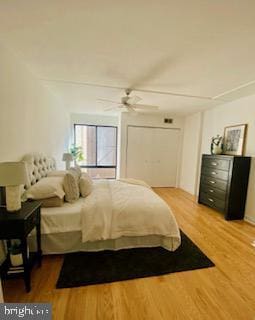 bedroom with ceiling fan and light wood-style flooring