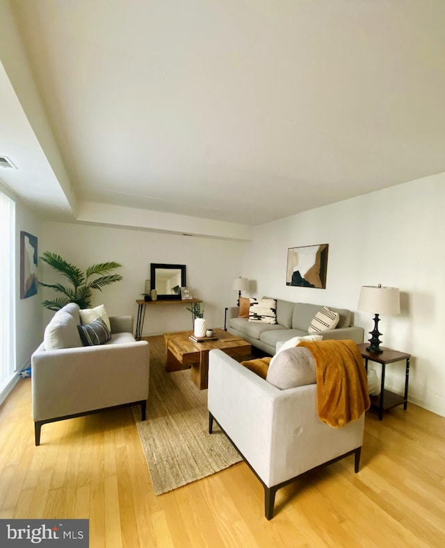 living room with light wood-style floors and visible vents