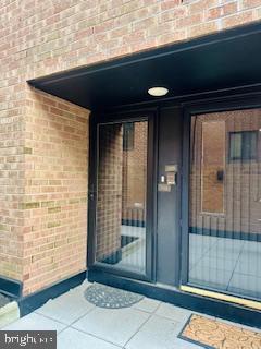 doorway to property with brick siding