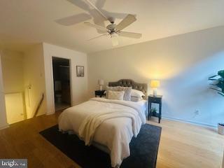 bedroom featuring a ceiling fan and wood finished floors