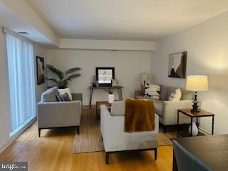 living room with a wealth of natural light and light wood-style flooring