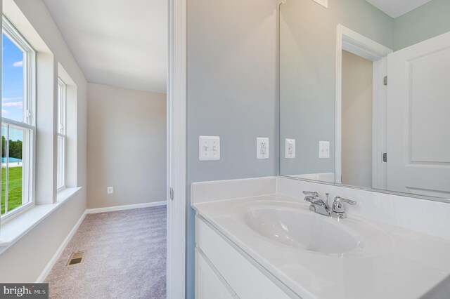 bathroom with baseboards, vanity, and visible vents