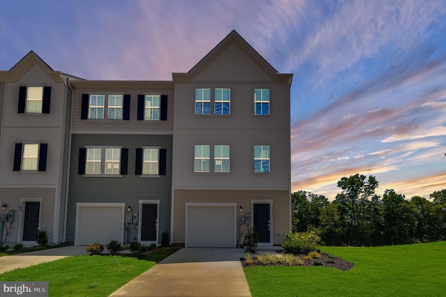 multi unit property with a lawn, an attached garage, and driveway