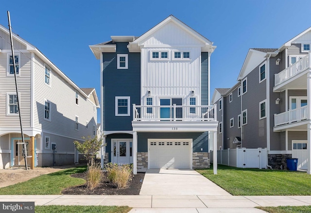 135 Walnut Ave, North Wildwood, NJ 08260 - view of front of home with board and batten siding, a garage, fence, a balcony, and concrete driveway