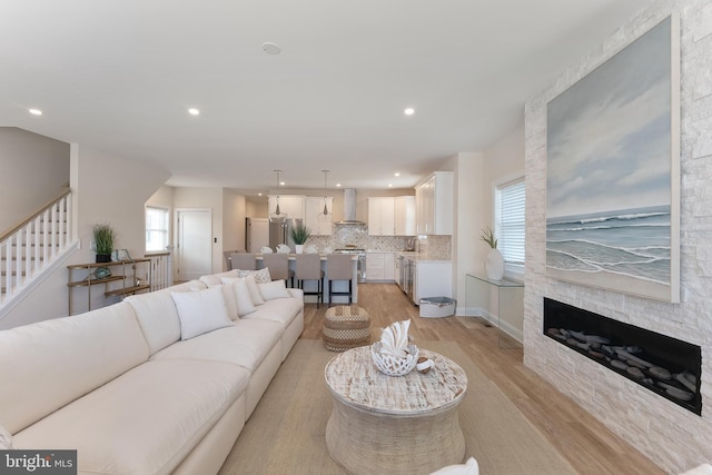 135 Walnut Ave, North Wildwood, NJ 08260 - living area with recessed lighting, light wood finished floors, a stone fireplace, and stairs