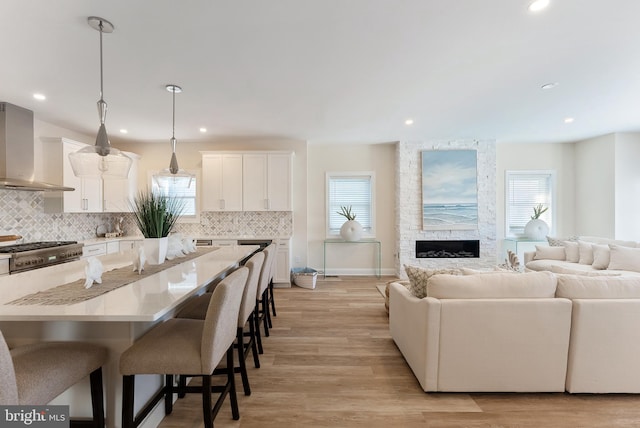 135 Walnut Ave, North Wildwood, NJ 08260 - living area with recessed lighting, a stone fireplace, a healthy amount of sunlight, and light wood finished floors
