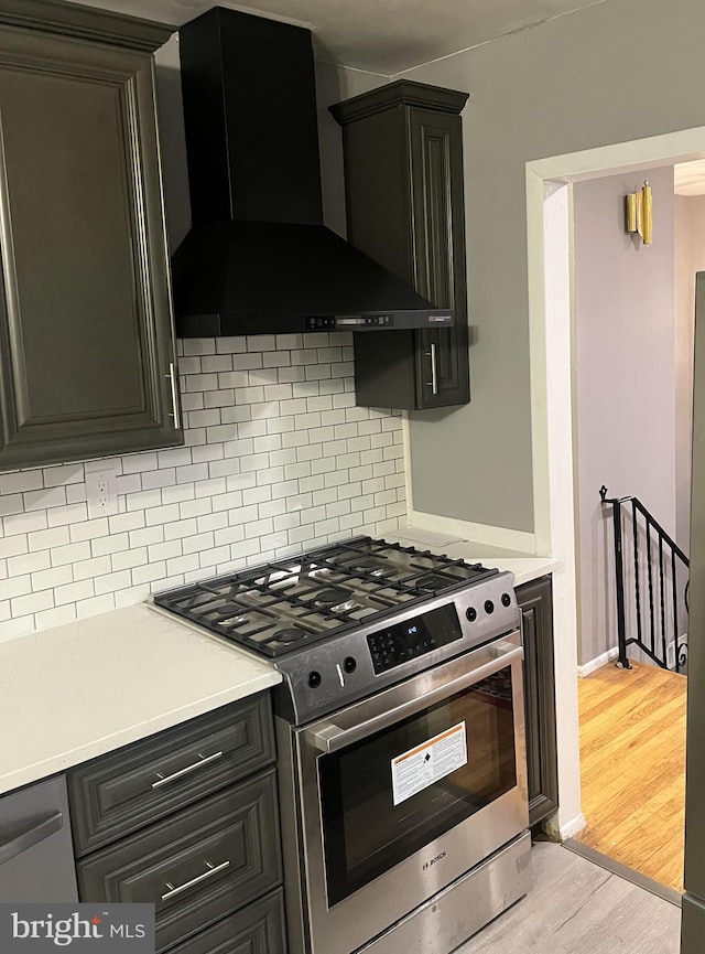 395 Hickory Ave, Carneys Point, NJ 08069 - kitchen featuring wall chimney range hood, gas range, light wood-style flooring, and light countertops