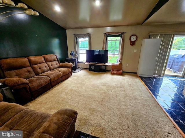 carpeted living room with lofted ceiling, baseboards, tile patterned floors, and recessed lighting