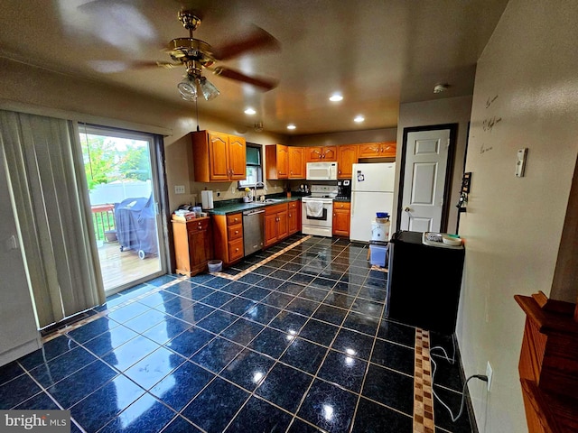 kitchen featuring brown cabinetry, white appliances, recessed lighting, a ceiling fan, and dark countertops