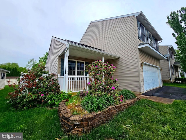 view of front of property with an attached garage, a porch, and driveway