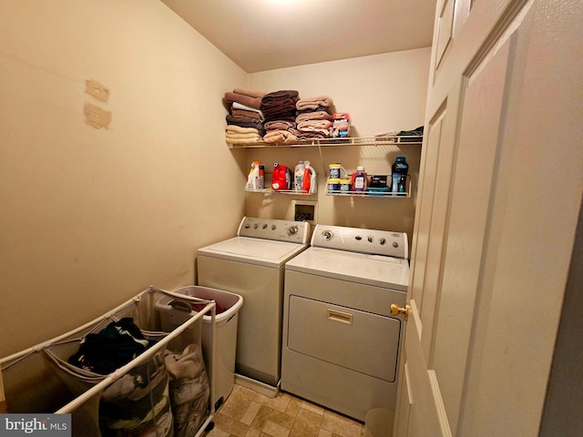 laundry area with washing machine and clothes dryer, laundry area, and light floors