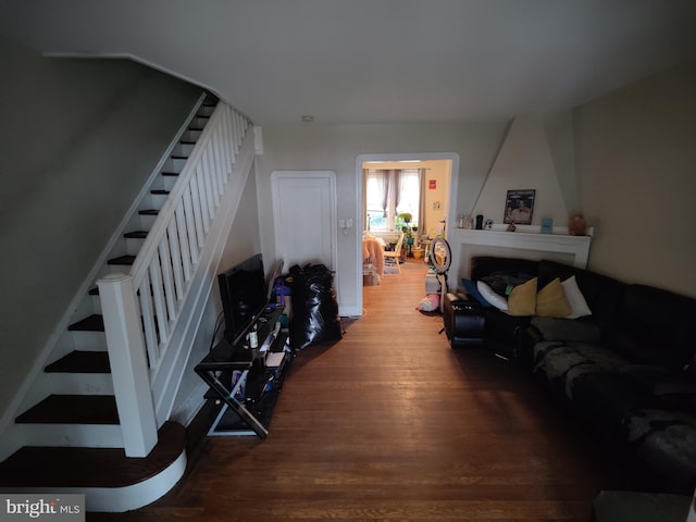 living room featuring stairs and wood finished floors