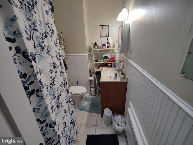 bathroom with vanity, a wainscoted wall, tile patterned floors, toilet, and a shower with shower curtain