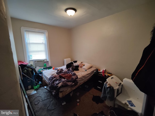 carpeted bedroom featuring radiator heating unit and cooling unit