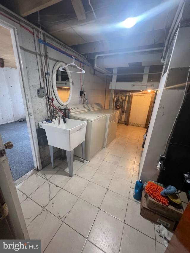 unfinished basement with washer and dryer and a sink