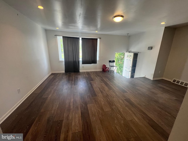 unfurnished living room featuring recessed lighting, baseboards, visible vents, and dark wood finished floors