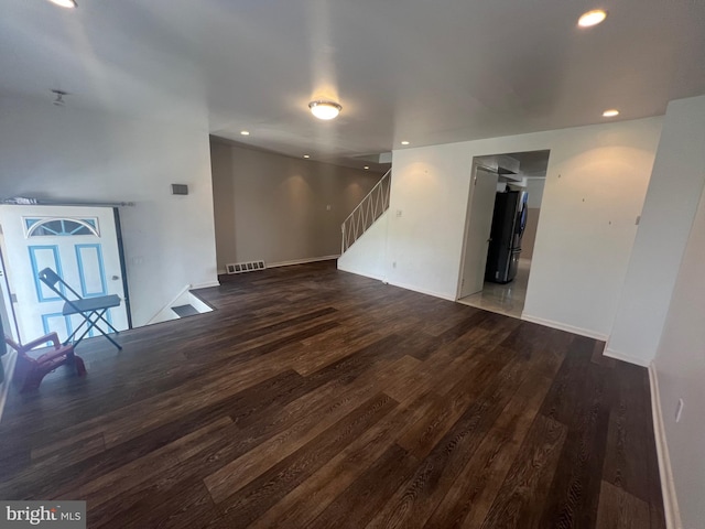 unfurnished living room with stairs, recessed lighting, visible vents, and wood finished floors