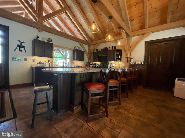 3401 Old Level Rd, Havre De Grace, MD 21078 - kitchen with wooden ceiling with exposed beams, a breakfast bar, hanging light fixtures, high vaulted ceiling, and light stone counters