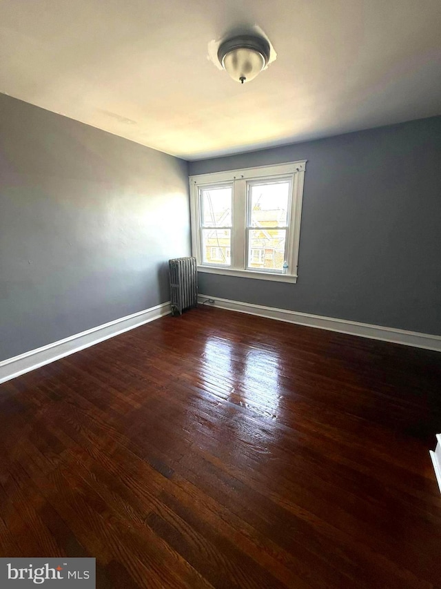 7124 Seaford Rd, Upper Darby, PA 19082 - spare room with baseboards, radiator, and wood finished floors
