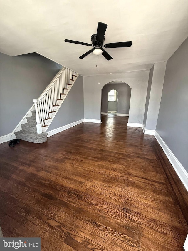 7124 Seaford Rd, Upper Darby, PA 19082 - unfurnished living room featuring baseboards, arched walkways, stairs, and ceiling fan