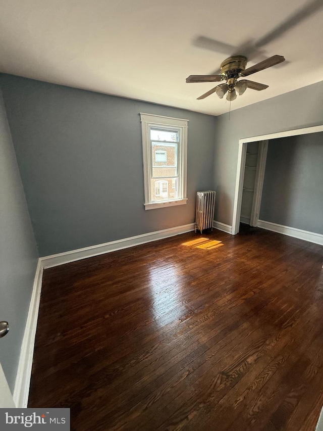 7124 Seaford Rd, Upper Darby, PA 19082 - unfurnished bedroom featuring a ceiling fan, baseboards, dark wood-style floors, and radiator