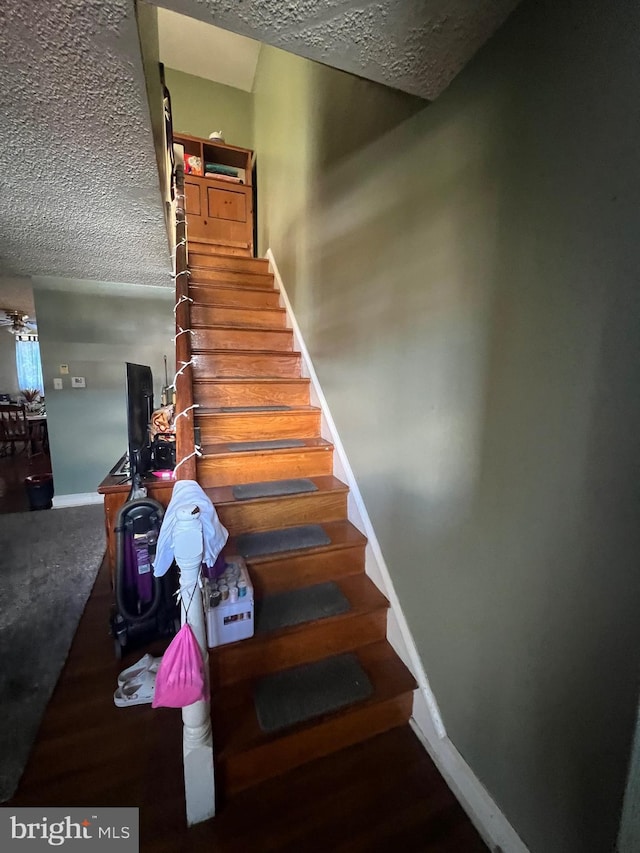 2818 Hellerman St, Philadelphia, PA 19149 - stairway featuring baseboards and a textured ceiling