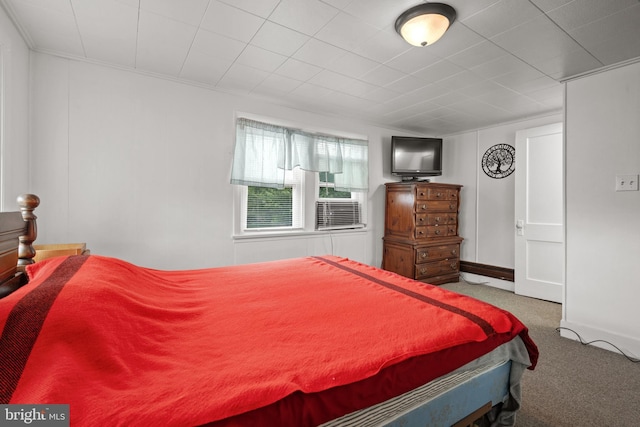 carpeted bedroom featuring crown molding