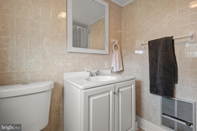 bathroom featuring vanity, tile walls, toilet, and visible vents