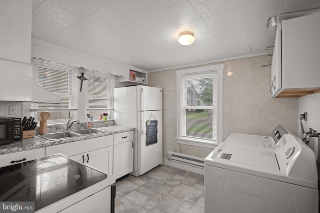 kitchen featuring a sink, freestanding refrigerator, washing machine and clothes dryer, electric range oven, and black microwave