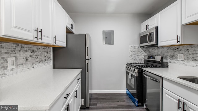 kitchen featuring dark wood-style flooring, backsplash, electric panel, and stainless steel appliances