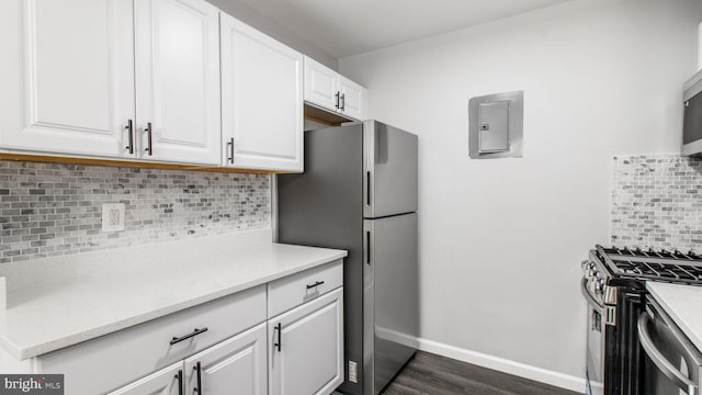 kitchen featuring light countertops, tasteful backsplash, stainless steel appliances, and white cabinetry