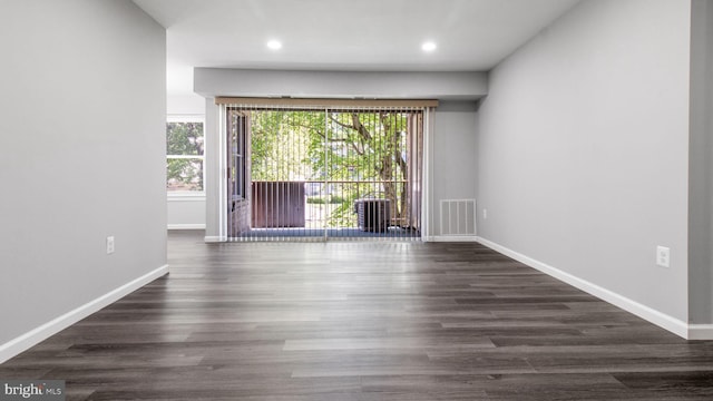 spare room featuring recessed lighting, baseboards, visible vents, and dark wood finished floors