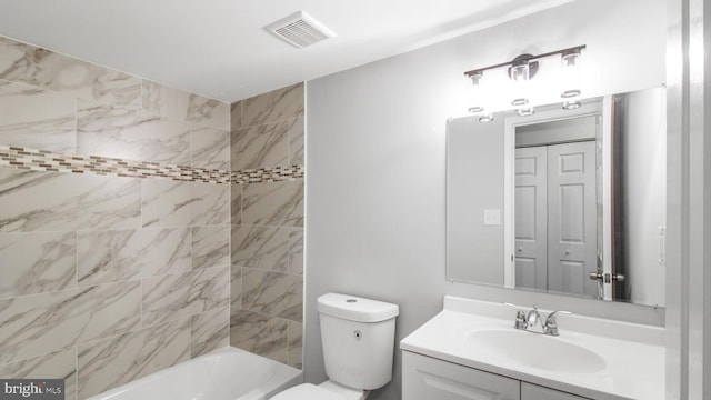bathroom featuring toilet, visible vents, shower / tub combination, and vanity