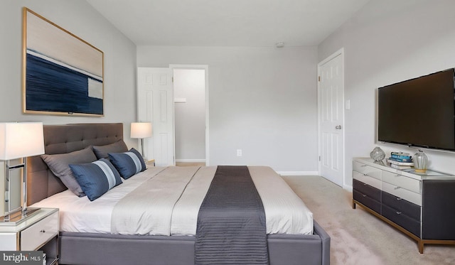 bedroom featuring baseboards and light carpet