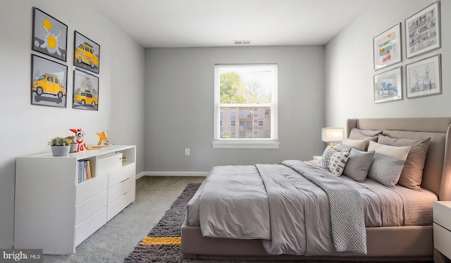 carpeted bedroom featuring visible vents