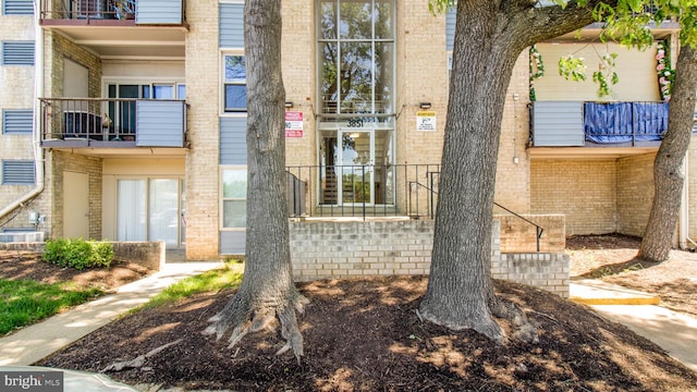 entrance to property featuring brick siding