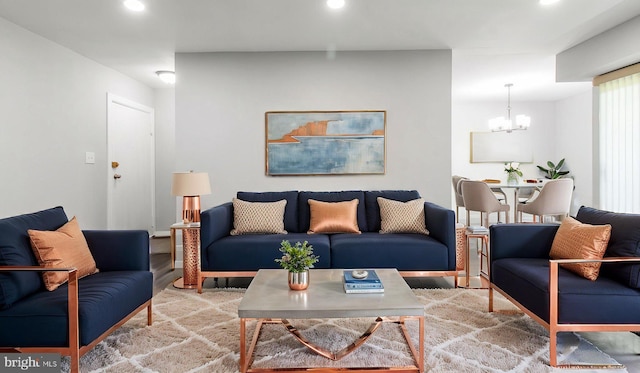 living area with recessed lighting, a notable chandelier, and wood finished floors