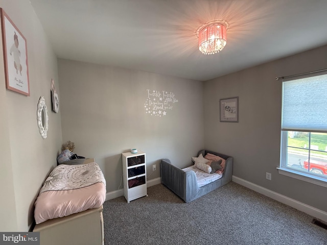 bedroom featuring carpet floors, baseboards, a chandelier, and visible vents