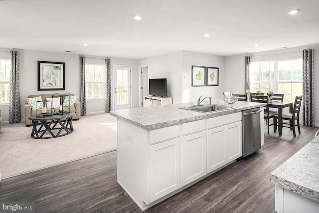 kitchen featuring a kitchen island with sink, stainless steel dishwasher, a sink, open floor plan, and recessed lighting