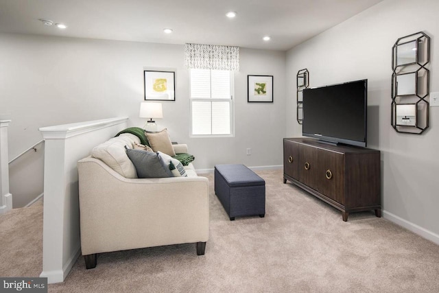 living area featuring light colored carpet, recessed lighting, and baseboards