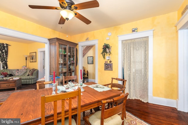 dining room featuring baseboards, ceiling fan, and hardwood / wood-style flooring
