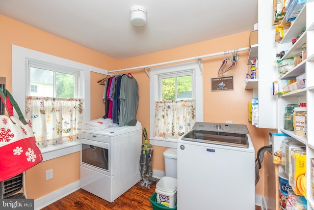 laundry room featuring laundry area, baseboards, wood finished floors, and washer and dryer