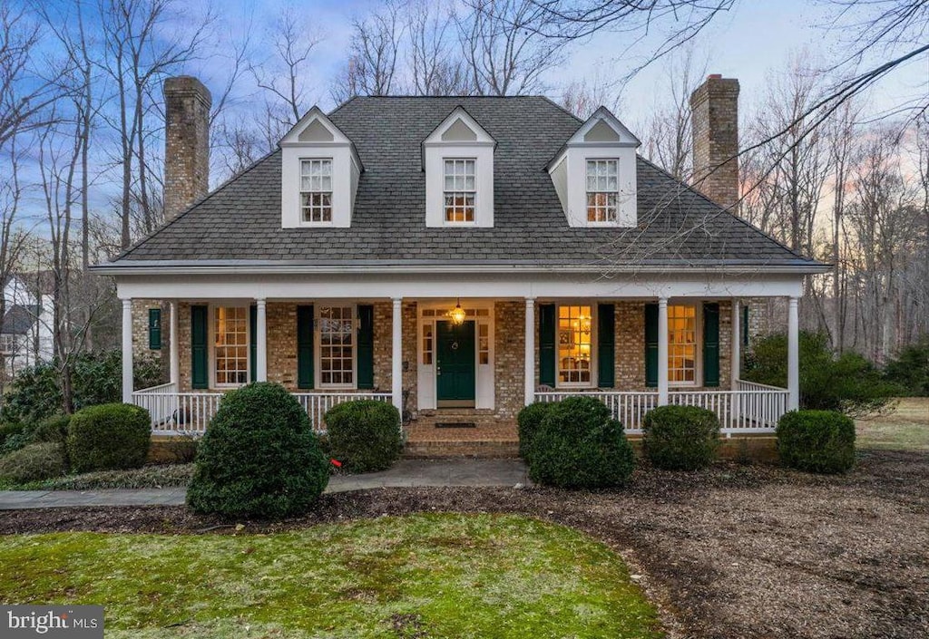 6008 Finchingfield Rd, Warrenton, VA 20187 - view of front of house with a chimney, a porch, and brick siding